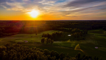 Obraz premium Aerial view of European centre golf club during sunset by drone