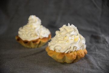 tartlets made of dough with cream and fruit