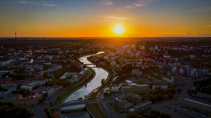 Naklejka na ściany i meble Aerial view of Vilnius panorama during sunset by drone