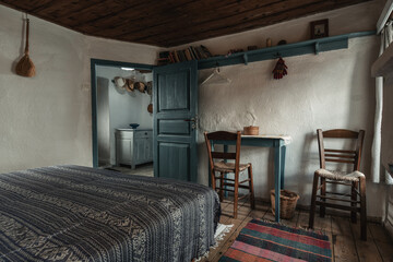 Traditional interior of old bedroom with handmade wooden furniture and traditional  folk ornament...