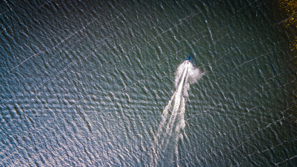 Top down view of motor boat in a lake by drone