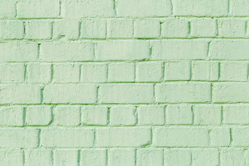 Background with brick, uneven texture wall. Brickwork is painted green color