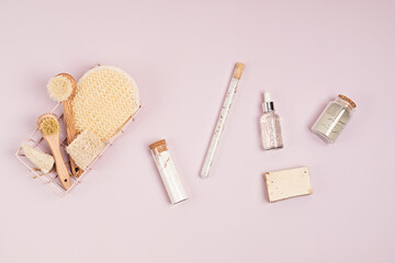 Eco friendly soap bar, brushes, cotton swabs, bath salt, clay mask and washcloth on lilac background. Zero waste sustainable lifestyle. Organic Self care, wellbeeing concept