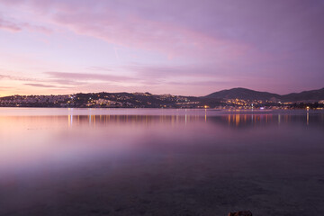 Sunset on the lake and city