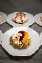 tartlets made of dough with cream and fruit