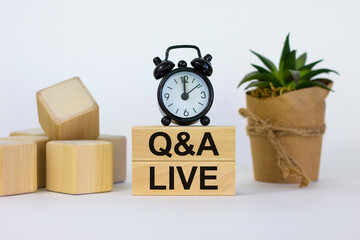 Q and A, questions and answers live symbol. Concept words 'Q and A live' on wooden blocks on a...