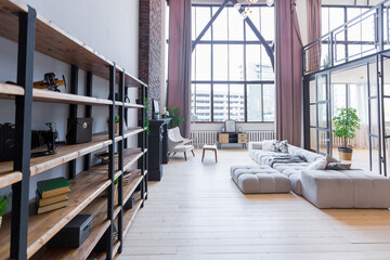trendy modern design two-level apartment with large high windows. The stylish living room and...