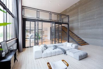 trendy modern design two-level apartment with large high windows. The stylish living room and...