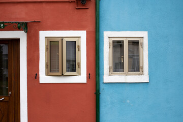 Fototapeta na wymiar Red and blue building facade details in Burano Italy