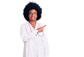 Young african american woman wearing doctor coat and stethoscope pointing aside worried and nervous...