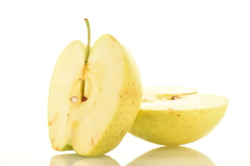 Two halves of juicy yellow apples, close-up, on a white background.