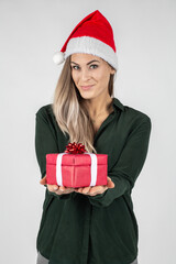 beautiful young woman wearing a santa hat with red Christmas gift