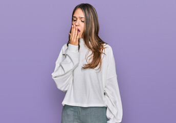 Young brunette woman wearing casual turtleneck sweater bored yawning tired covering mouth with hand. restless and sleepiness.