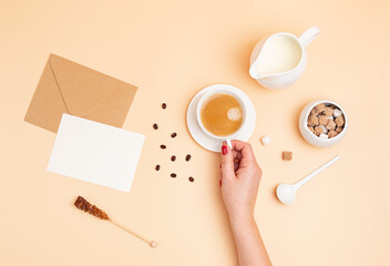 Flat lay with morning coffee, sugar and milk. Minimal composition with copy space over beige backgound