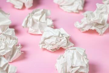 Crumpled paper on a pink background. A pile of crumpled paper. Creative crisis. Lack of ideas