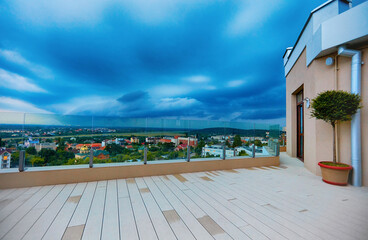 view from a rooftop pation on the city in a valley in the evening