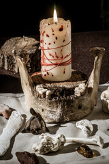 Witchcraft attributes: burning bloody candle and bones - 404104694