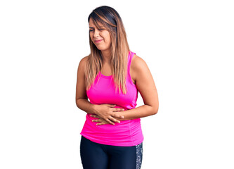 Young beautiful woman wearing sportswear with hand on stomach because indigestion, painful illness feeling unwell. ache concept.