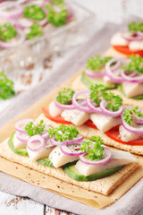 Sandwiches with herring and vegetables