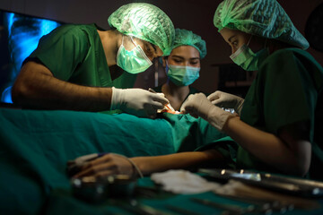 Doctors and nurses are using tools to perform surgical procedures on patients in the operating room. Medical concept. Background blurred.