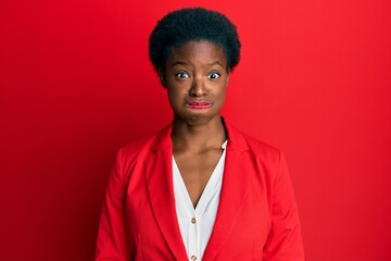 Young african american girl wearing business clothes puffing cheeks with funny face. mouth inflated with air, crazy expression.