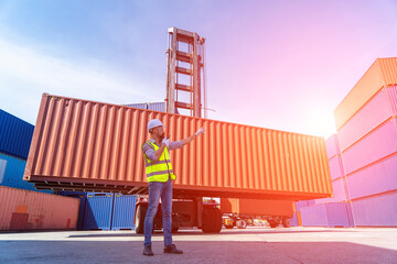 Engineers are overseeing the transportation of cargo with containers inside the warehouse....