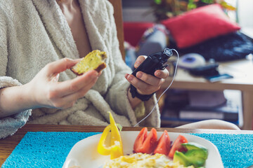 Modern diabetes treatment, woman checking glucose level and dosing insulin with insulin pump before her healthy breakfast