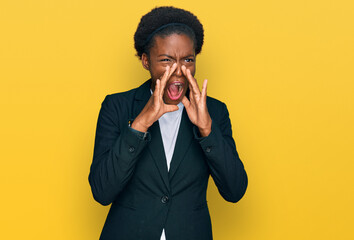 Young african american girl wearing business clothes shouting angry out loud with hands over mouth