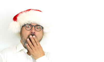 Portrait of scared or surprised man wearing Christmas hat on white background