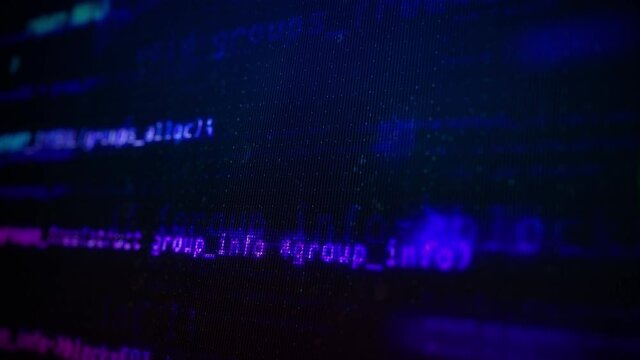 Close-up of Colorful Neon Program Code on a Computer Screen in Defocus. Software development and hacking concept. Technology, coding, programming