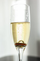 glass of champagne with wedding rings inside