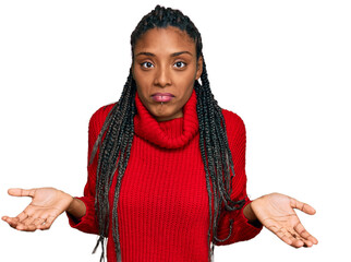 African american woman wearing casual winter sweater clueless and confused expression with arms and...