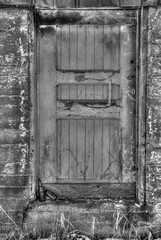 Two beer bottles on steps of a doorway to an old building