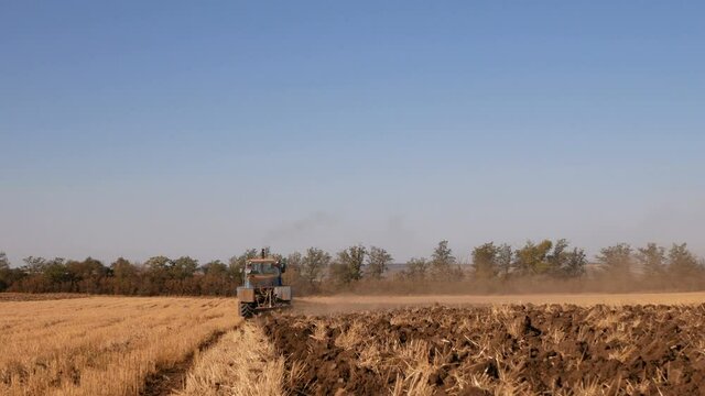 Tractor plowing fields -preparing land for sowing