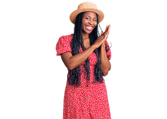 Young african american woman wearing summer hat clapping and applauding happy and joyful, smiling...