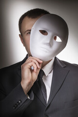 Man covering his face with a mask. Concept on the topic of secrecy of the person