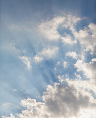 Fototapeta na wymiar White cloud and rays of sun over roof of house