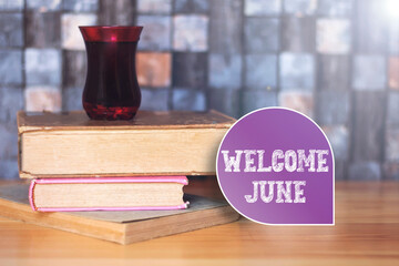 Welcome june word in purple card with books