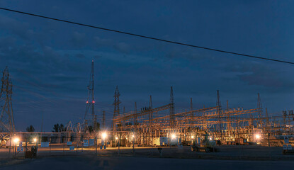 Ottawa Hydro Hawthorne Road Transformer Station at night with steel towers and high voltage lines...