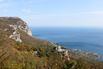 Fototapeta na wymiar Scenic autumn view from the top of the mountain Baydar gate to the Foros church and coastline of Black sea in Crimea