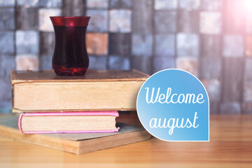 Welcome august word in blue card with books