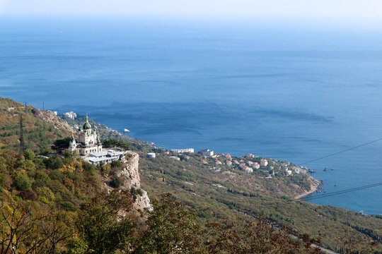 Scenic autumn view from the top of the mountain Baydar gate to the Foros church and coastline of Black sea in Crimea