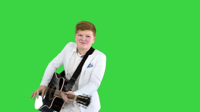 Boy moves like Elvis with guitar on a Green Screen, Chroma Key.