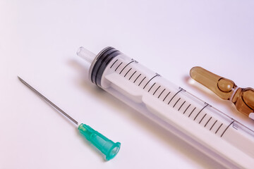 Syringe, needle and a medication vial on a white background