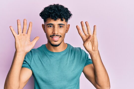 Young arab handsome man wearing casual clothes showing and pointing up with fingers number nine while smiling confident and happy.