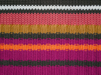 Background with knitted bright colorful sweater pattern. Natural colors.