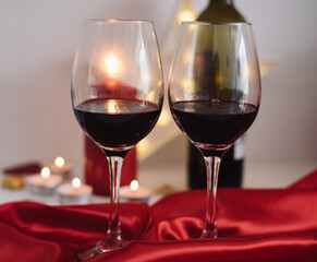 Two glasses of red wine and candles create a romantic, unforgettable evening for lovers. In Lovely Valentine day in 14th February get a surprise. Gifts, surprises, declarations of love