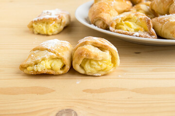 Cookies with curd filling. Delicious confectionery dessert. Cooking products are on a wooden table.