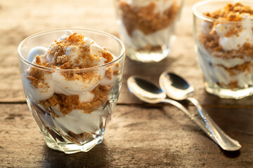 Portions of Yogurt and crumbled amaretti biscuits in glasses
