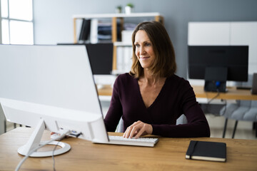 Woman In Office Using Business Computer